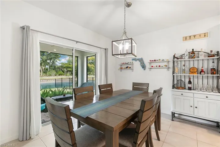 Dining space featuring light tile patterned floors and hanging lights