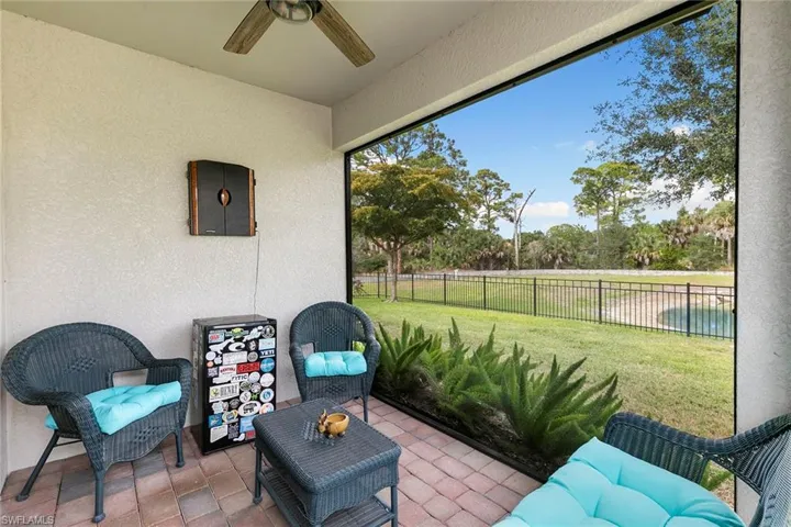 Sunroom with a patio area and ceiling fan