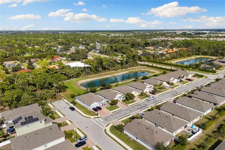 Aerial view of residential area featuring a nearby body of water