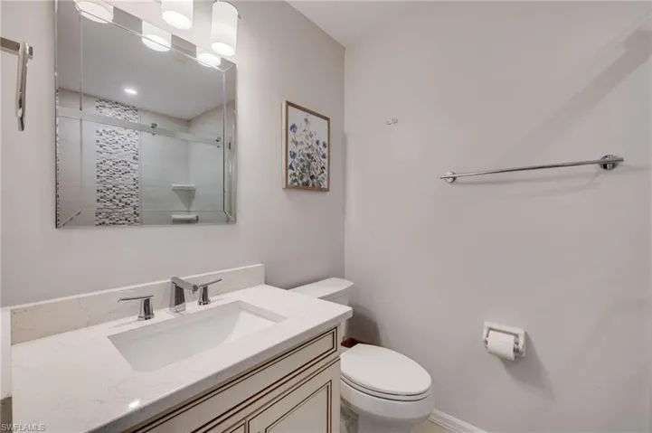 Bathroom with new tiled shower, cabinetry and countertops