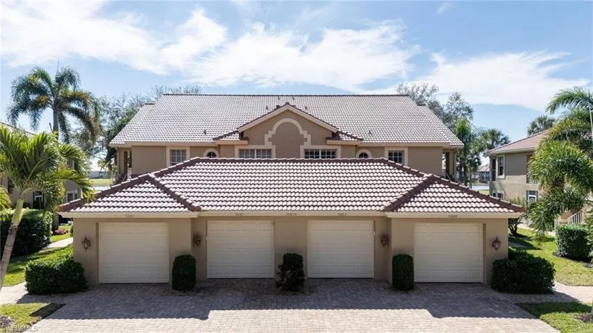 Mediterranean style home with stucco siding, a tile roof, and detached garages