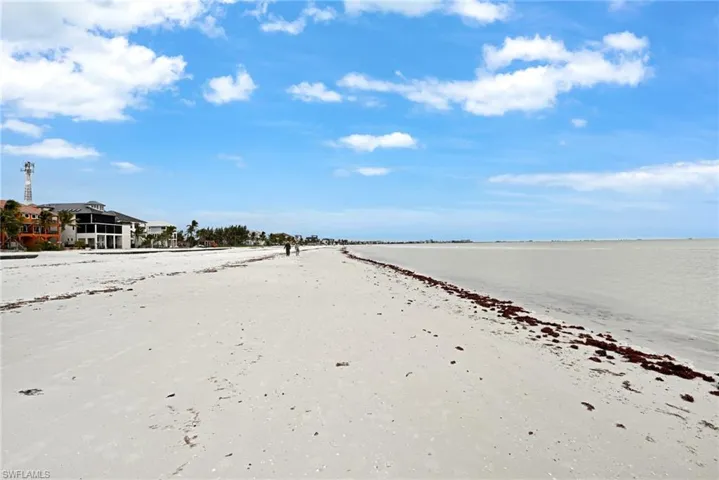View of street with a beach view and a water view
