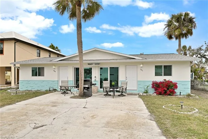 Rear view of house with a yard and a patio area