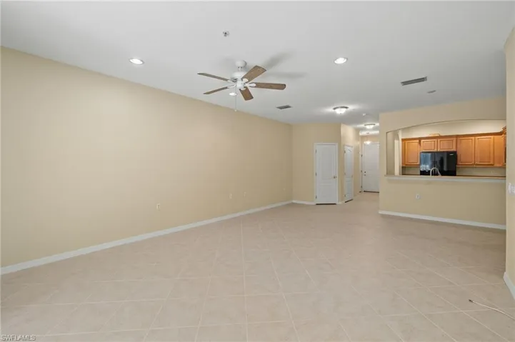 Unfurnished living room featuring ceiling fan, recessed lighting, and light tile patterned floors