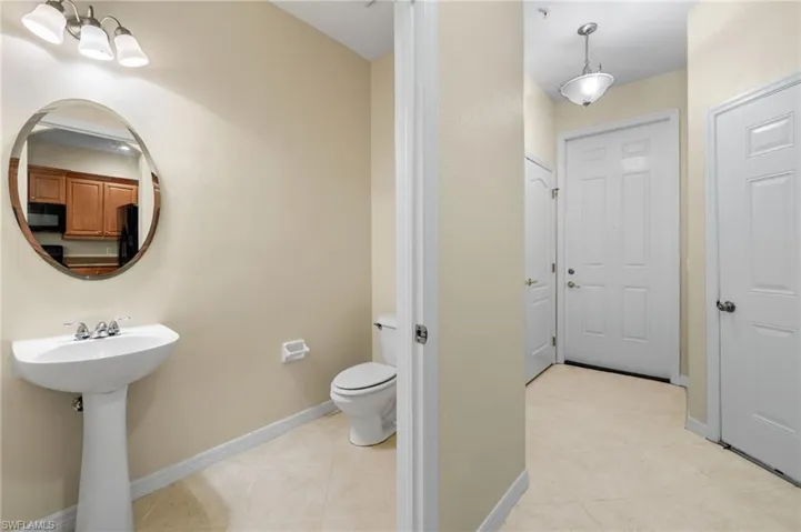 Bathroom with light tile patterned floors and toilet