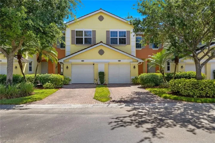 View of front of house with decorative driveway, stucco siding, and a garage
