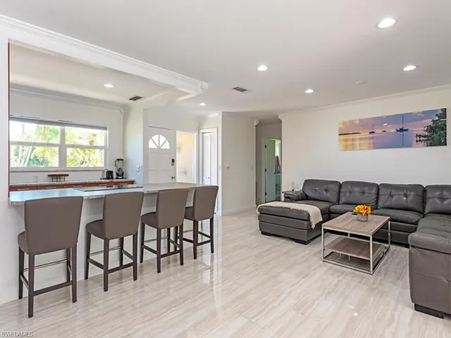 Living room featuring ornamental molding and recessed lighting