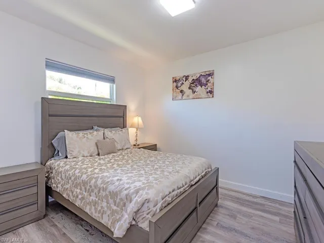 Bedroom featuring light wood-style floors and baseboards