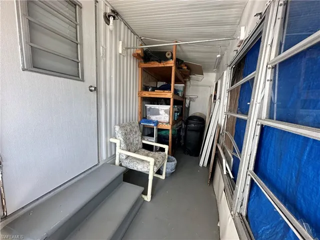 Side Entrance & Storage Area.  Windows are broken