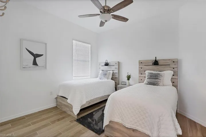 Bedroom with light hardwood / wood-style flooring and ceiling fan