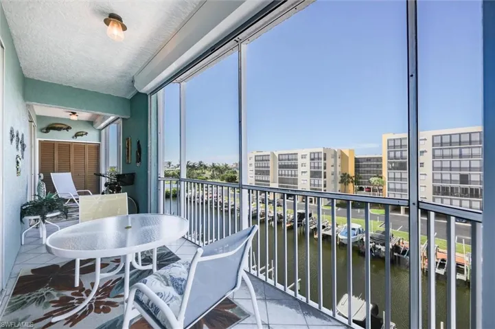 Balcony featuring a sunroom and a water view
