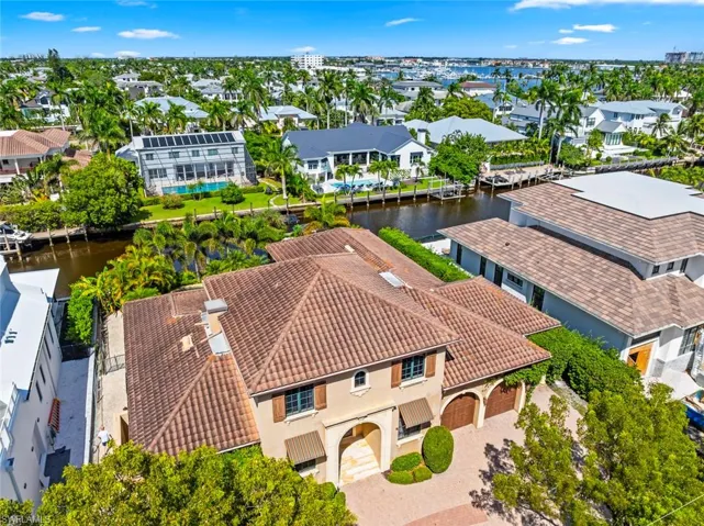 Aerial perspective of suburban area featuring a large body of water