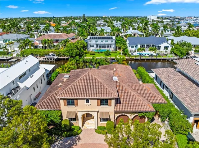 Aerial perspective of suburban area featuring a nearby body of water