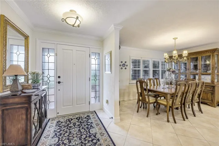 Custom front door with side lights . . . large, neutral tile on the diagonal.