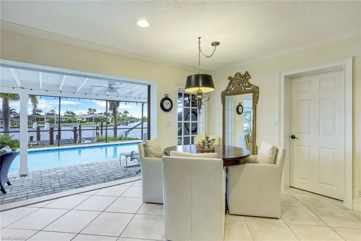 Dining area in the Family Room offers a lovely view of the pool and intersecting canals.