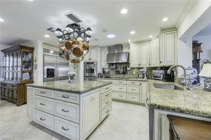 TRUE Chef's Kitchen features a built-in LG fridge, immense center island, soft-close drawers, pantry & slide-out shelves.