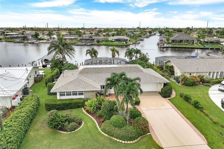 Gorgeously updated western exposure pool home offers QUICK ACCESS to some of the best fishing & boating in SW Florida!