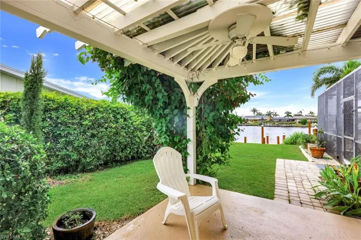 This private patio outside the third bedroom is one of the outdoor rooms with a lovely water view in this lushly landscaped, fenced yard.