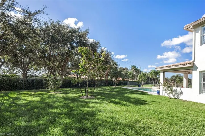 View of  side yard featuring a fenced in pool