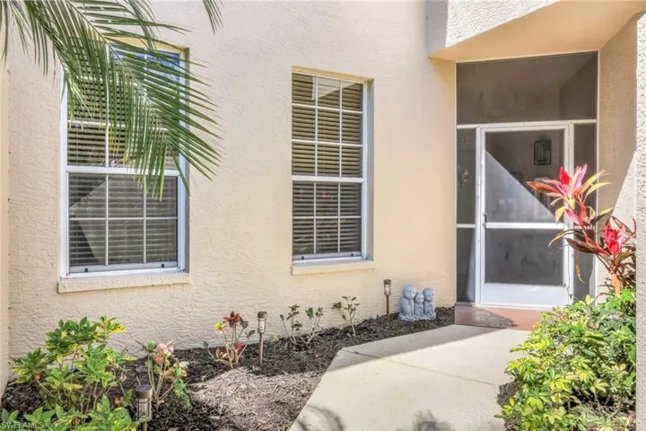 View of exterior entry featuring stucco siding