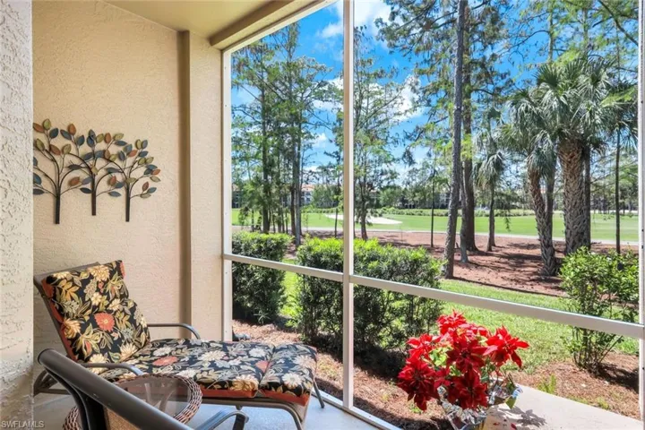Sunroom featuring view of golf course