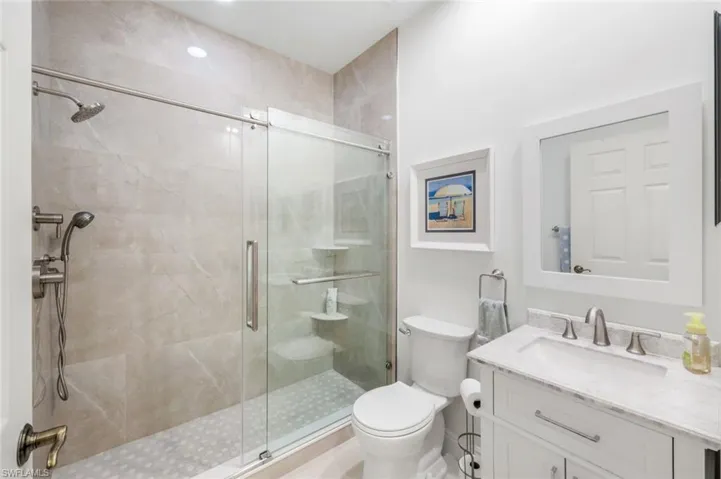 Full bathroom featuring vanity and a shower stall