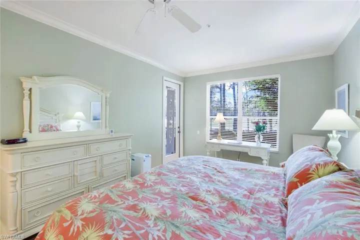 Bedroom featuring access to exterior, ornamental molding, and a ceiling fan