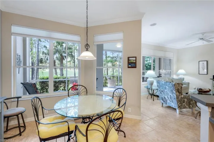 Dining area featuring ornamental molding, light tile patterned floors, and ceiling fan