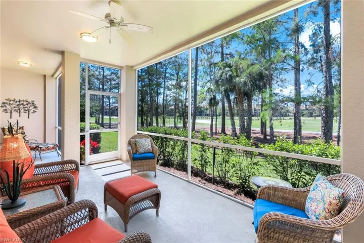 Sunroom featuring a wall of windows, finished concrete flooring, and a ceiling fan