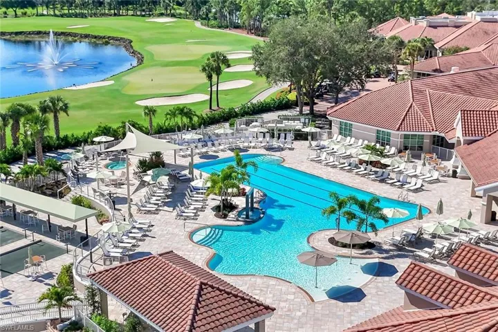 Community pool featuring a water view, a patio, and golf course view