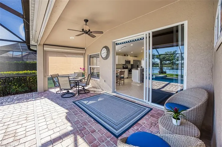 View of patio with a lanai and ceiling fan