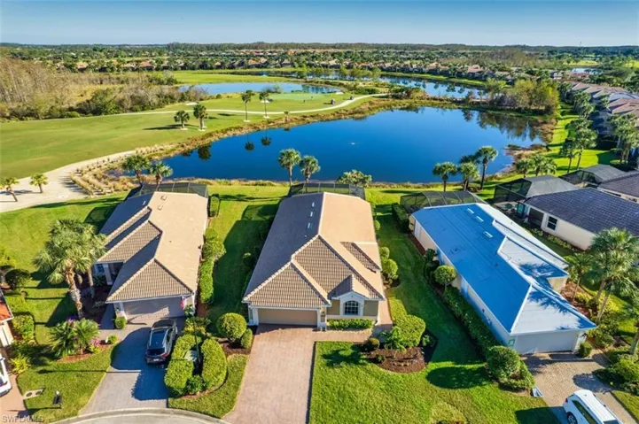 Birds eye view of property with a water view