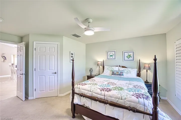 Carpeted bedroom with ceiling fan