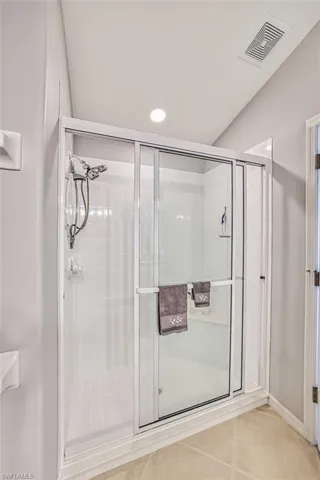 Bathroom with tile patterned flooring and walk in shower