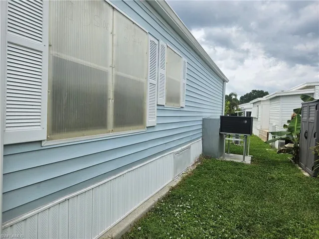 View of property exterior with a lawn