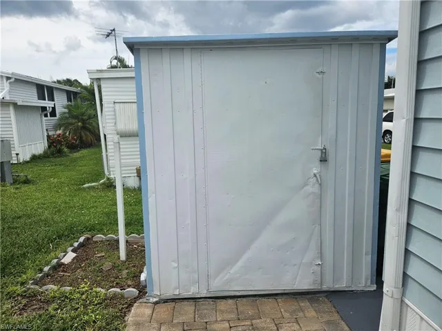 View of outdoor structure featuring a yard