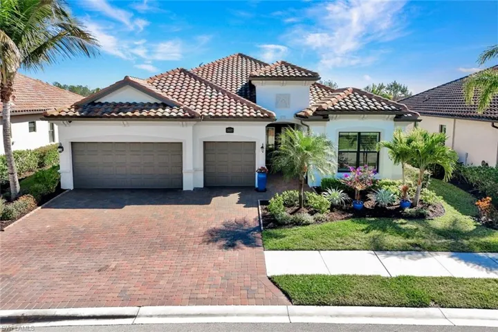 Front Elevation with Wide Paved Driveway and Custom Landscape