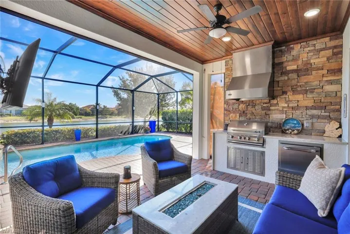 Custom Outdoor Kitchen with Oversized Hood Vent and Custom Stone Wall