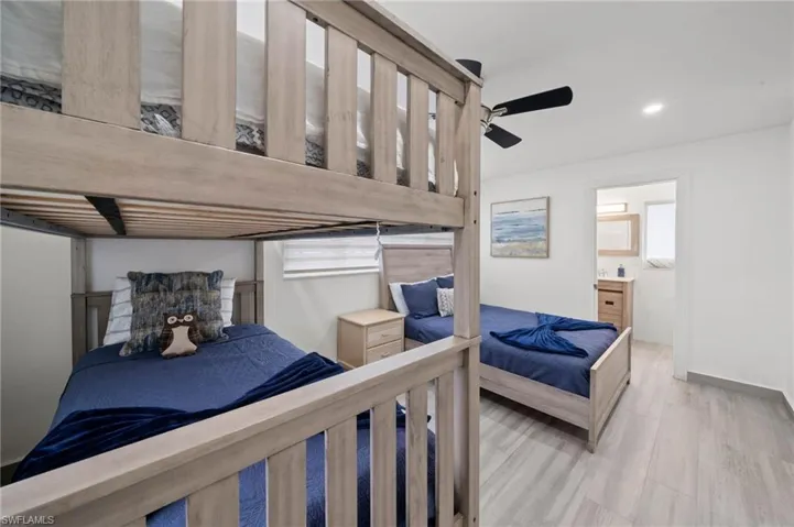 Bedroom featuring wood-finish flooring, a ceiling fan, and recessed lighting