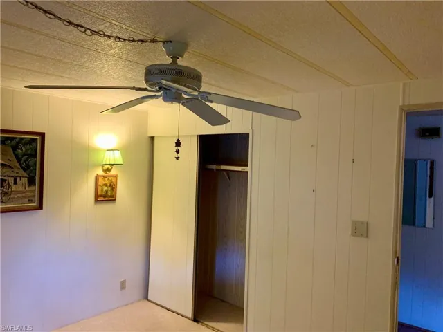 Unfurnished bedroom with carpet, ceiling fan, and a closet