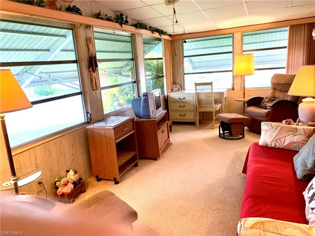 Living room with carpet and a paneled ceiling