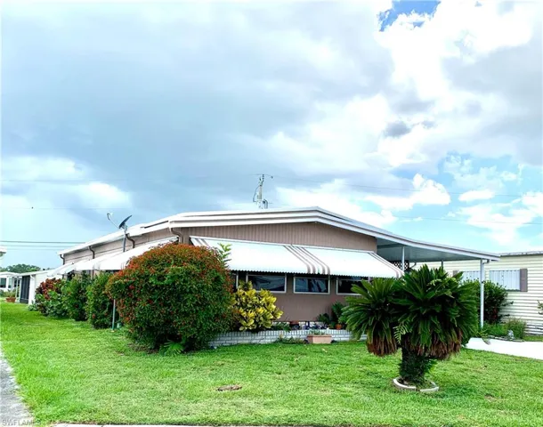 View of home's exterior with a yard