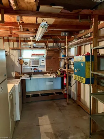 workshop area, washing machine and clothes dryer, and extra fridge