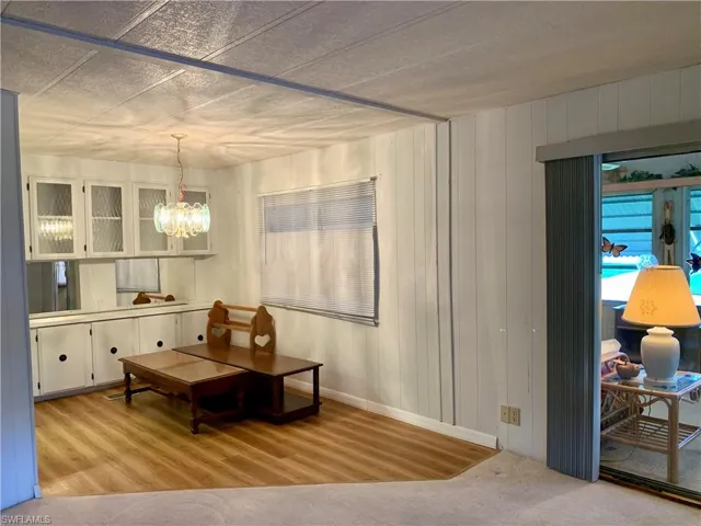 Dining room with an inviting chandelier and light hardwood / wood-style floors
