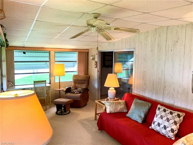 Carpeted room featuring a paneled ceiling