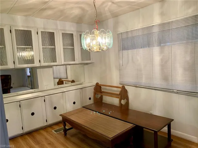 Dining space featuring a chandelier and light hardwood / wood-style flooring