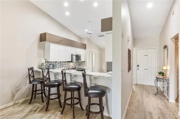 breakfast bar to kitchen and front door on right