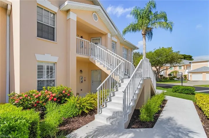 View of property with stairs