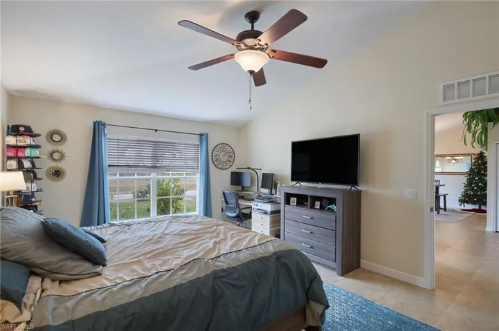 Bedroom with ceiling fan and lofted ceiling