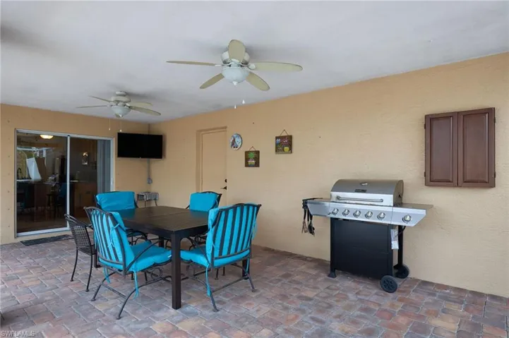View of patio featuring grilling area and ceiling fan